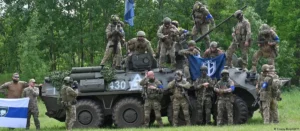Fighters from the "Freedom of Russia" legion in front of a captured Russian military vehicle